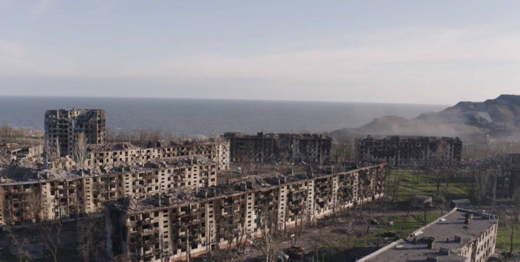 Aerial view of burned-out apartment blocks in the Livoberezhnyi district of Mariupol beside the Sea of Azov.